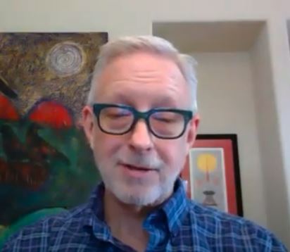 John Boylr wearing blue button up shirt with black glasses screen shot of Sunday Service Guided Meditation