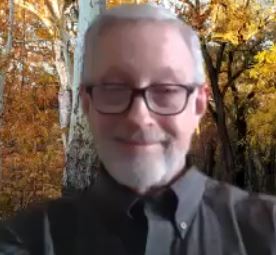 Screenshot of john boyles online guided meditation for CSL man with glasses smiling