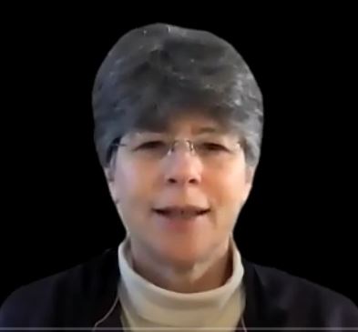 Screenshot of Kathy Fernandes online Sunday Service Guided Meditation for New Thought Science of Mind Service woman wearing white turtle neack and navy jacket with short hair