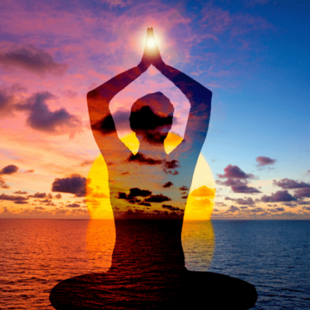 Image of a shadow figure meditating in front of the ocean